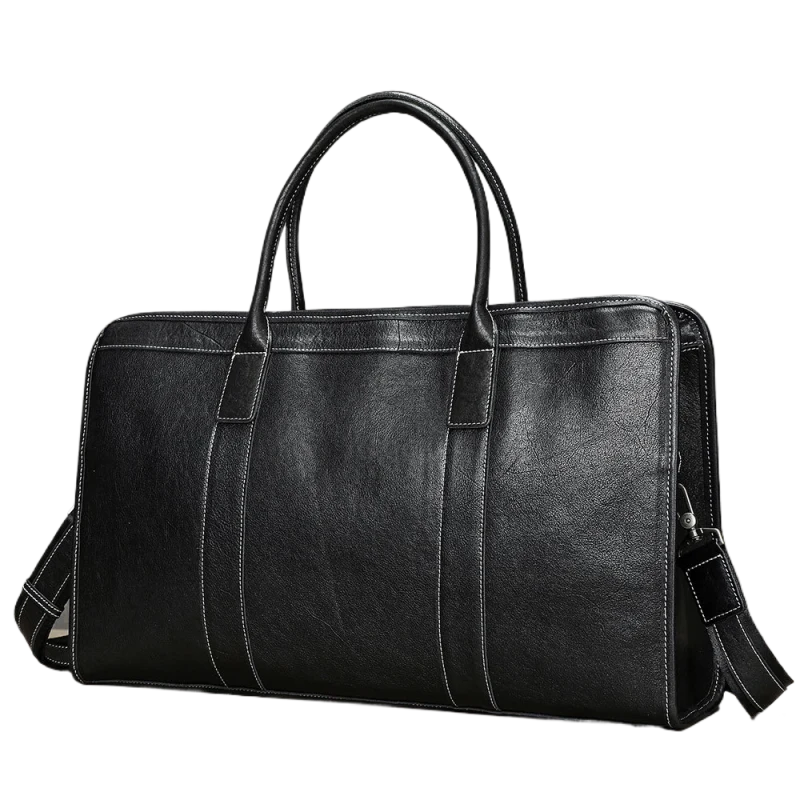 Sac à main en cuir noir posé sur une surface en bois avec fond gris