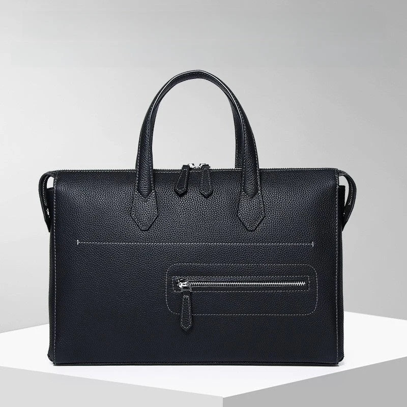 Mallette en cuir noir posée sur un support blanc avec arrière-plan gris